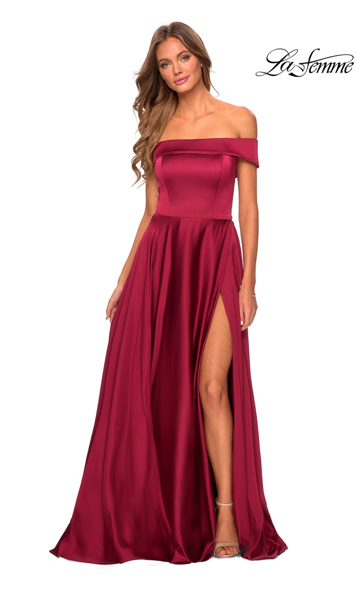 A woman poses against a white background in the La Femme Off-Shoulder Long A-Line Prom Dress 28978, floor-length burgundy with a high slit. The La Femme prom dress logo appears in the top right corner.